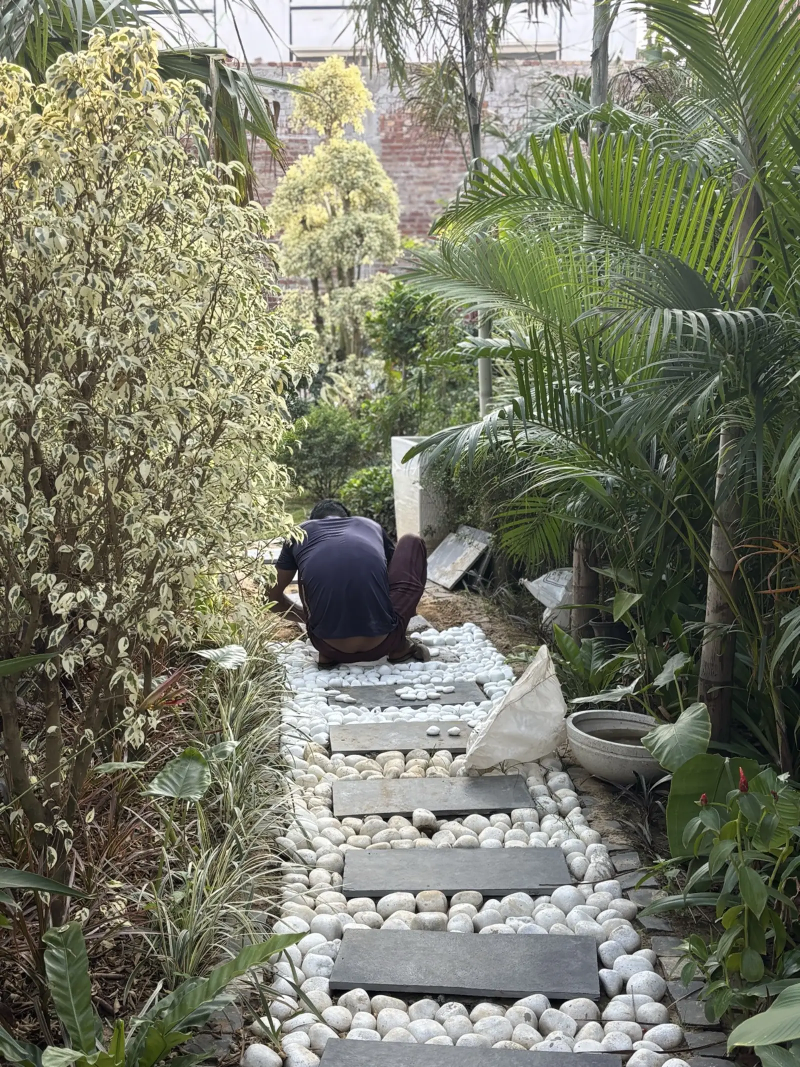 Craftsman laying stepping stone path
